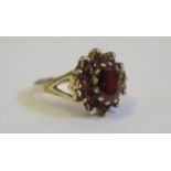 A 9ct Yellow Gold and Garnet Cluster Ring, size L, 2.6g