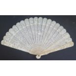 A 19th Century Chinese Carved and Pierced Ivory Brisé Fan, the ribs with approximately 60