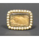 A Georgian Gold Memorial Ring set with lock of hear, gold thread and bordered by pearls, size A, 5.
