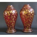 A Pair of 19th Century Cranberry Glass Vases with gilded vine leaf decoration, 24cm. Both with