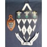 A Tin Magdalen College Coat of Arms (30cm including hanging loop) and one on oak (11cm)