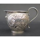A Small Continental Silver Creamer Jug with embossed c-scroll decoration, 39g, 5.5cm high