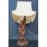 A Chinese Carved Wooden Immortal Table Lamp, 63cm inc. shade