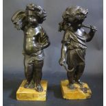 A Pair of Cast Bronze Putti, one bearing a sickle, vine and grape and the other a bushel of wheat