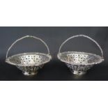 A Pair of Georgian Silver Baskets with swing handles and pierced decoration, stamped with lion
