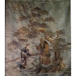 A 19th Century Chinese Gold Thread on Silk Embroidery decorated with two figures in a landscape,