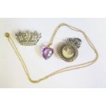 A Carved Amethyst Heart Pendant and two coronet brooch and pendant
