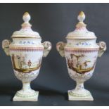 A Pair of Veuve Perrin Faience Rams Vases with ram's mask handles and covers, decorated with
