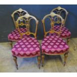 A Set of Four Edwardian Walnut and Inlaid Side Chairs with overstuffed seats. Faults