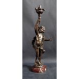 A Spelter Electric Lamp in the form of Cupid bearing a torchère, 39.5cm high. Needs professional