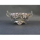 A Victorian Pierced Silver Two Handled Bowl with embossed foliate scroll decoration, London 1892,