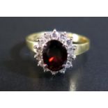 An 18ct Gold, Dark Ruby and Diamond Cluster Ring, size N, 3.5g