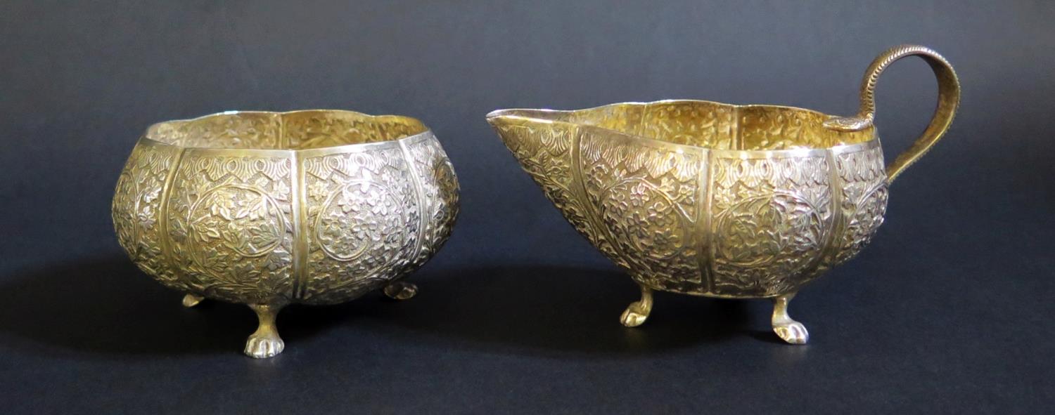 An Asian White Metal Sugar and Creamer with embossed foliate decoration, 249g