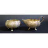 An Asian White Metal Sugar and Creamer with embossed foliate decoration, 249g