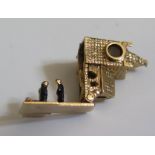 A 9ct London Gold Charm in the form of a church with hinge opening to reveal three enamelled figures