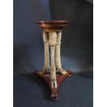 An Occasional Table raised on three cloven hoof legs, 53cm high
