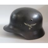 A WWII German Luftwaffe Helmet with single decal, stamped Q64 and original leather liner