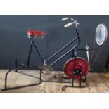 A Spencer, Heath & George Ltd. Exercise Bike with adjustable tension cast iron flywheel.