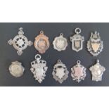 Nine Silver Fobs and darts brooch, 76.8g