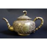 A Chinese Silver Teapot decorated with applied prunus leaf decoration and faux bamboo handle and