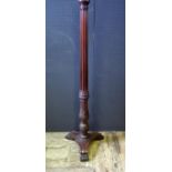 A Carved Mahogany Standard Lamp decorated with acanthus leaf and on scrolling tripod feet