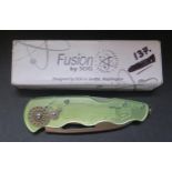 A Fusion by SOG Fish On (FF-21) clear green knife with fishing reel action, boxed new old stock