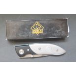 A Puma Special Edition Damascus Folding Knife with leather sheath