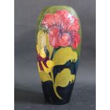 A Moorcroft Hibiscus Decorated Green Ground Vase, initialled WM, 32cm