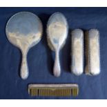 A George V Silver Backed Five Part Dressing Table Set including hand mirror, comb and three brushes,