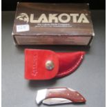 A Lakota Small Folding Knife with leather pouch and belt loop, boxed new old stock