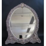 A Large Edward VII Silver Easel back Dressing Table Mirror decorated with putti, satyrs, scrolling