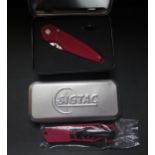 An Eickhorn Solingen Slimcut, red, tin case AND Sigtac Sigarms Skeleton, tin case, boxed new old