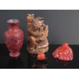 A Chinese Carved Cinnabar Vase (13cm) and Buddha, both with Hok Eong & Co. labels, carved wooden