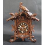 A Black Forest Cuckoo Clock with movement initialled G.H.S., 33cm