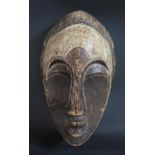 A West African Gabon Carved and Painted Balsa Wood Spirit Mask, 31cm