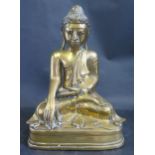 An Antique Asian Cast Bronze Figure of Buddha Seated with enamel eyes and paste inlay, possibly