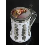 A Bohemian White Overlay Slice Cut Glass Beer Tankard with porcelain top decorated with a coquettish
