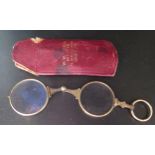 A Gilt Lorgnette in leather sleeve