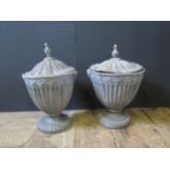 A Pair of Neoclassical Style Lead Urns and Covers with swag decoration, 51cm tall