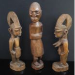 An African Carved Hardwood Figure and pair of softwood figures, tallest 38cm