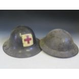 Two British Army Tin Helmets. One painted with Red Cross and dated 1941. Also two Vent Grills?