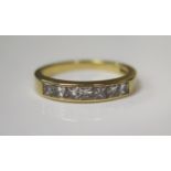 An 18ct Yellow Gold and Princess Cut Seven Stone Channel Set Diamond Half Eternity Ring, .66ct, size