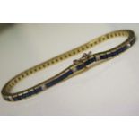 An 18ct Yellow Gold, Sapphire and Diamond 7.25" Line Bracelet,, set with 53 square cut sapphires (