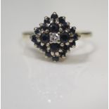 An 18ct Gold, Sapphire and Diamond Cluster Ring, London 1969, 13mm head, size S.5, 4.4g