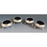 A Set of Four Victorian Silver Salts with embossed foliate decoration and resting on three hoof feet