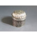 A 19th Century Dutch Silver Cylindrical Box embossed with figures,6cm wide x 5.5cm high, London 1887