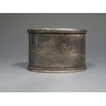 A Russian Silver Oval Napkin Ring decorated with a landscape and sleigh two horses and three people,