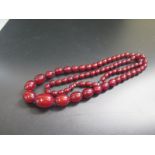 A Faux Amber Graduated Bead Necklace, largest bead 24x18mm, 52.4g
