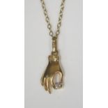 An 8K Hand Pendant holding a single diamond and on a fine 18" chain (rubbed marks), 3.3g gross