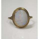 A 9ct Yellow Gold and White Opal Dress Ring, 7x9mm stone, size O, 2.1g